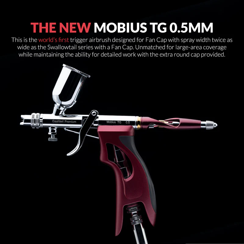 Gaahleri Mobius TG 0.5mm trigger airbrush in metallic red and silver, designed with a fan cap for wide spray coverage and precision work, shown against a black background with product description.